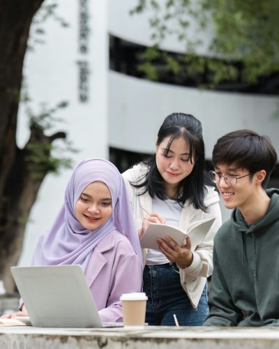 A group of happy multiracial students at the college with Muslim and Asian students grouped together