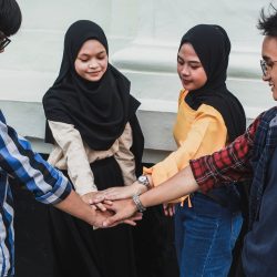 Group of asian friends doing team hand shake